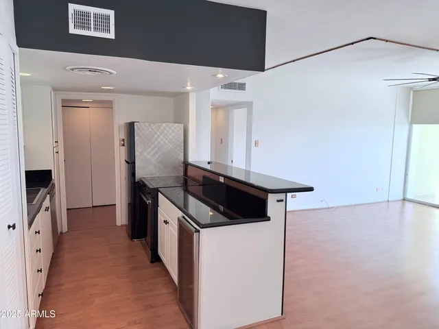 a kitchen with stainless steel appliances granite countertop a stove and a refrigerator