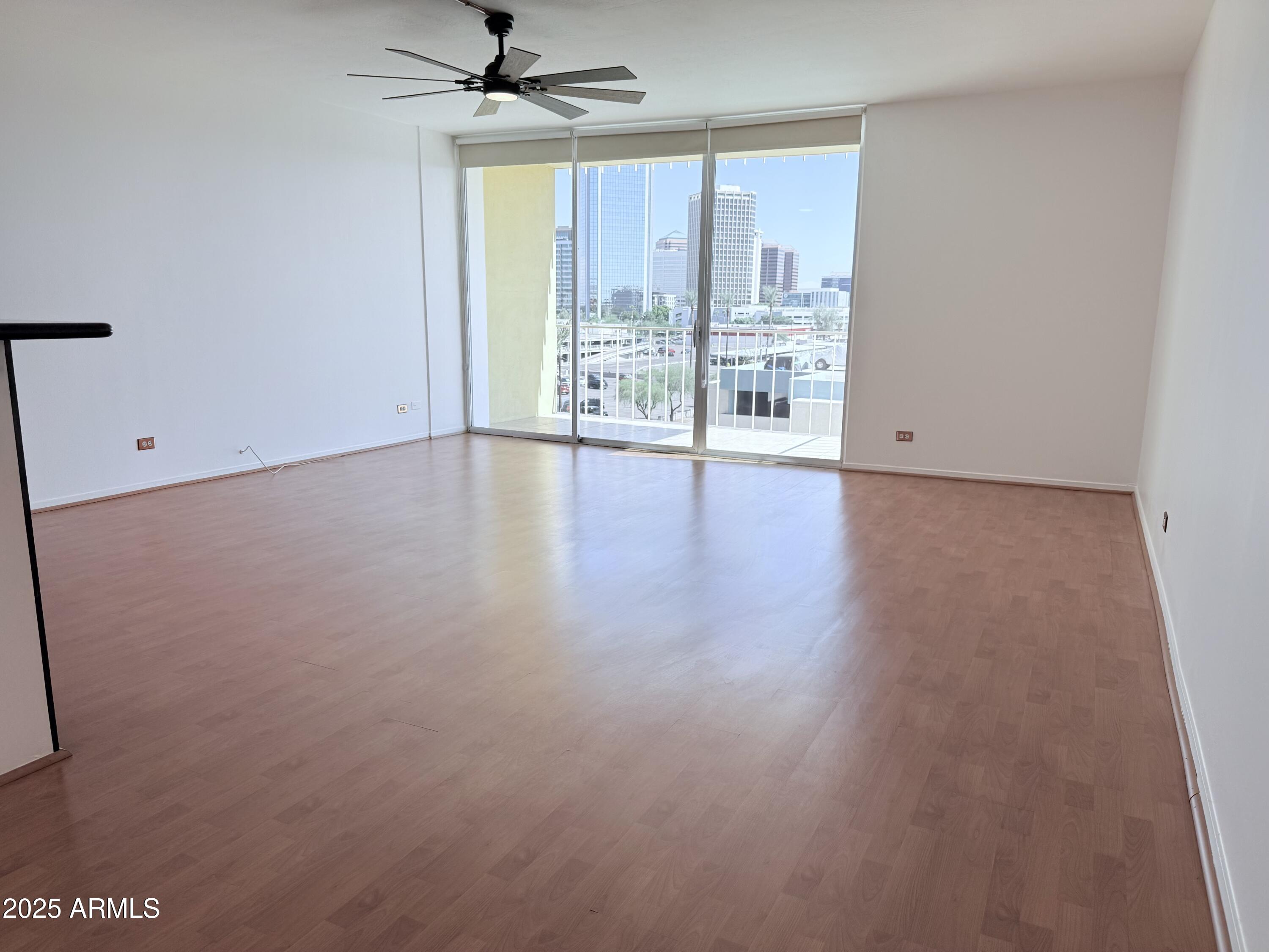 207 West Clarendon Avenue, Unit 4H Phoenix, AZ 85013 - Photo 25 of 37 wooden floor in an empty room with a window