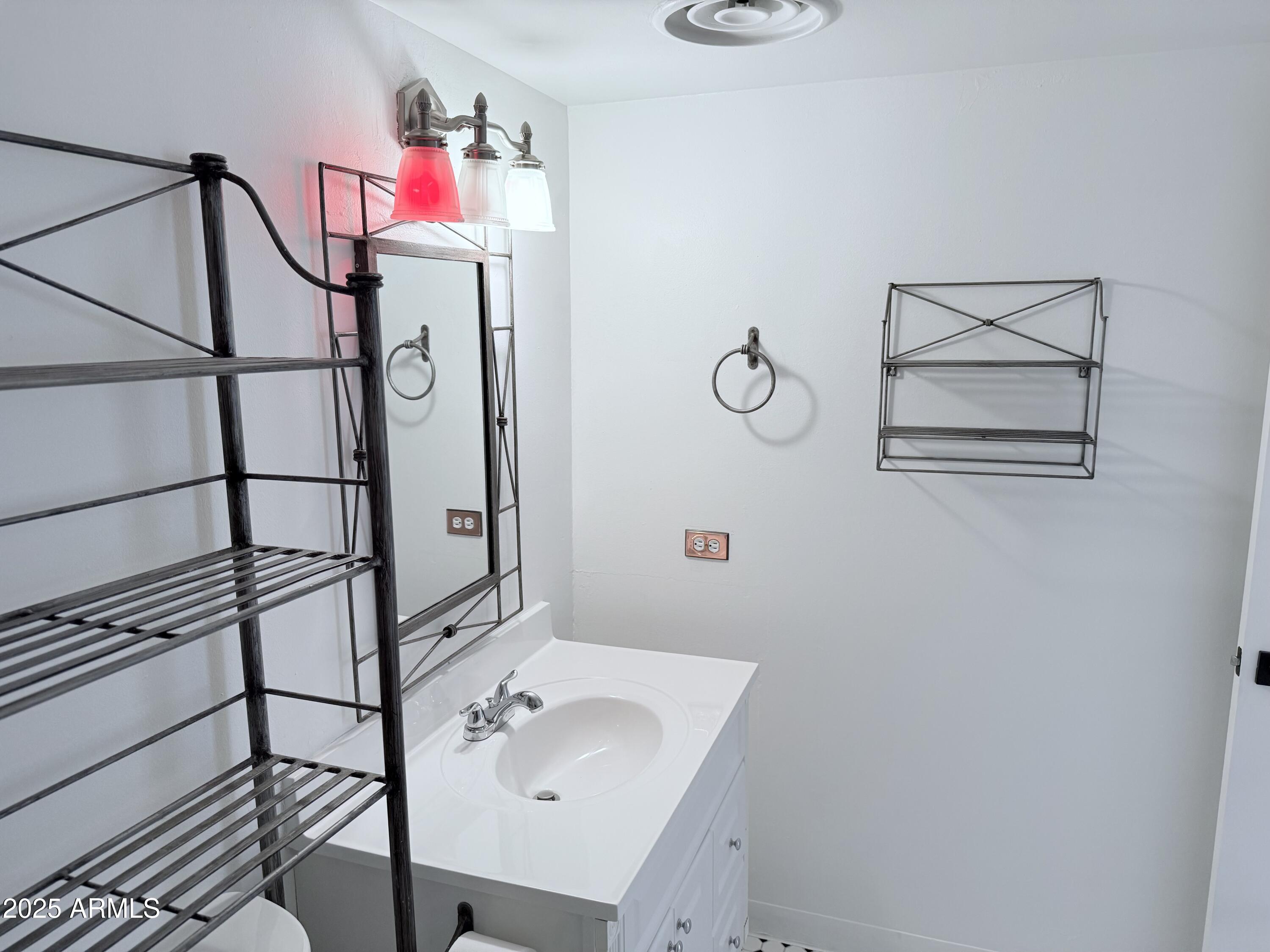 207 West Clarendon Avenue, Unit 4H Phoenix, AZ 85013 - Photo 27 of 37 a bathroom with a sink and mirror
