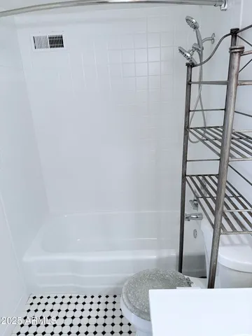 a view of a big room with windows and hardwood floor