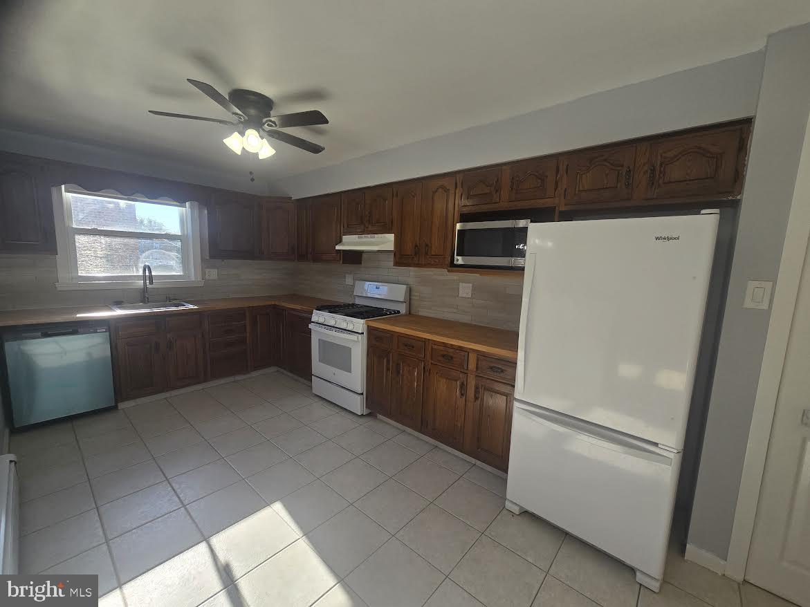 3800 Nedla Road Philadelphia, PA 19154 - Photo 14 of 31 a kitchen with stainless steel appliances granite countertop a sink a stove a refrigerator with grey cabinets