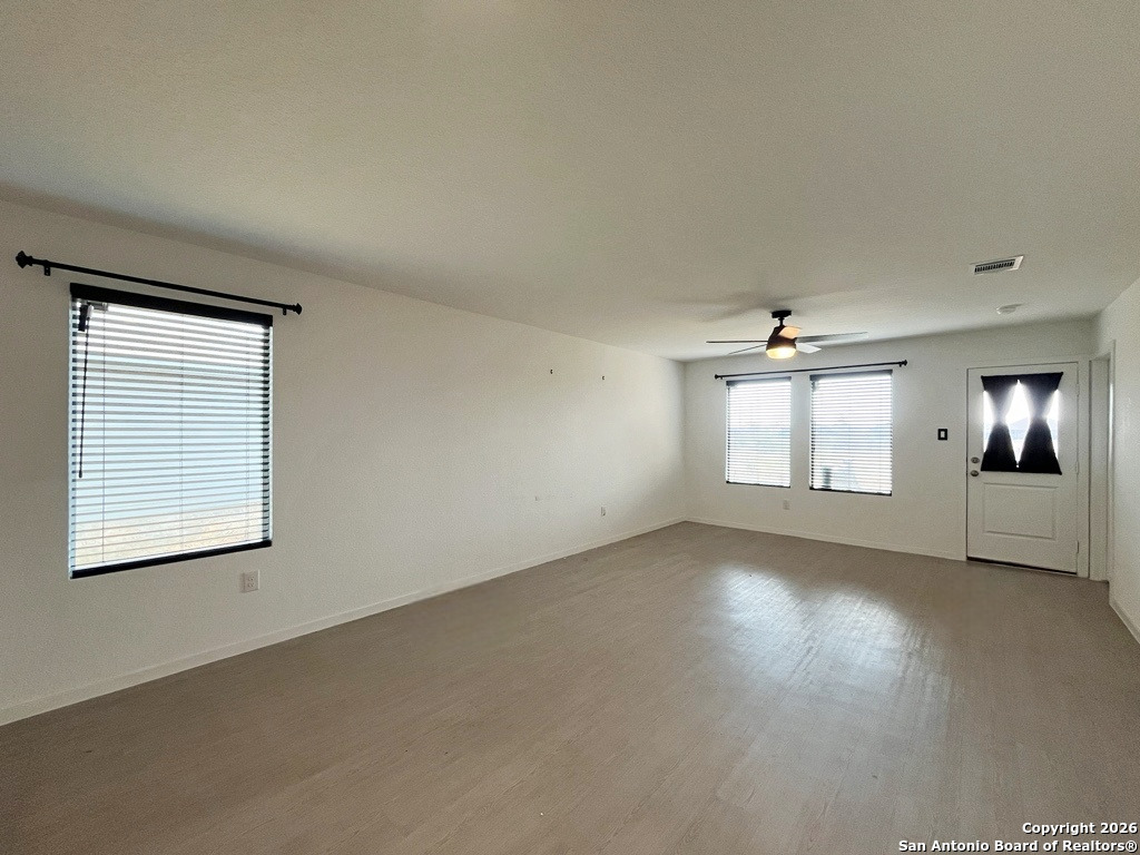 248 Cowboy Ridge Pleasanton, TX 78064 - Photo 12 of 37 an empty room with windows and fireplace