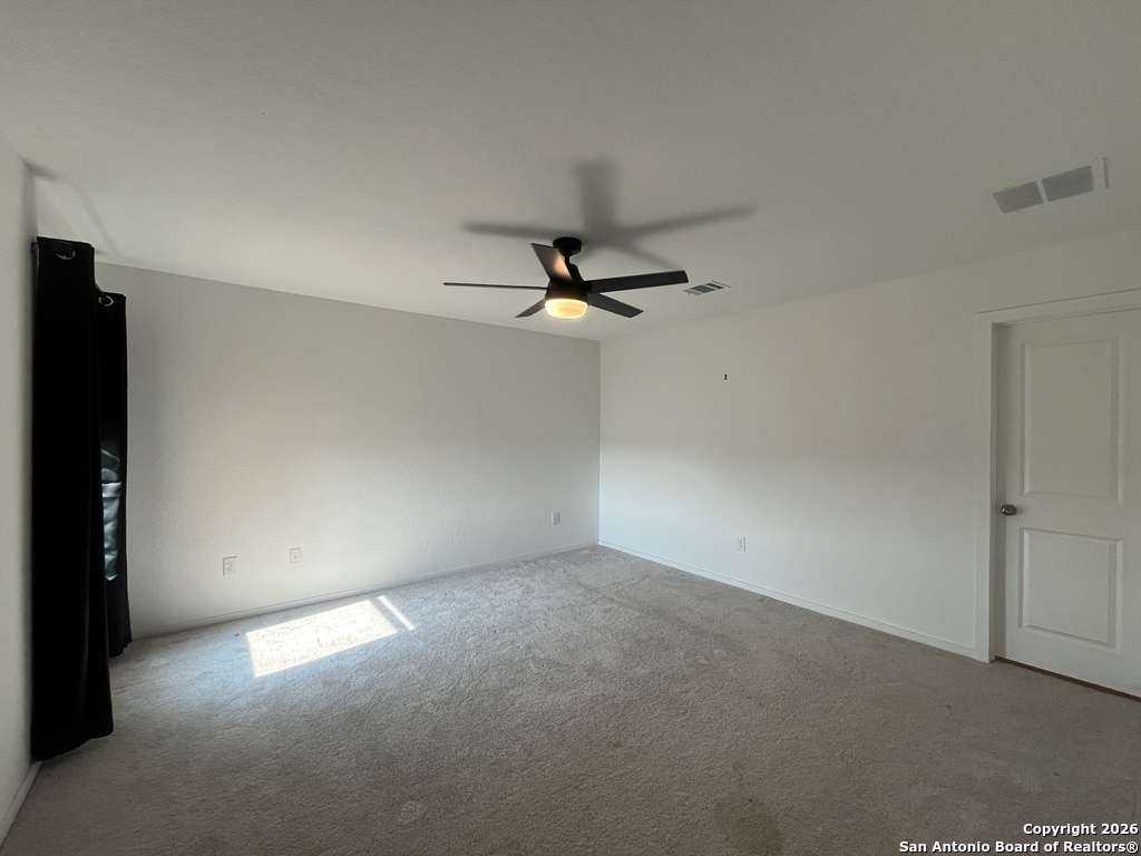 248 Cowboy Ridge Pleasanton, TX 78064 - Photo 15 of 37 an empty room with a ceiling fan and a window