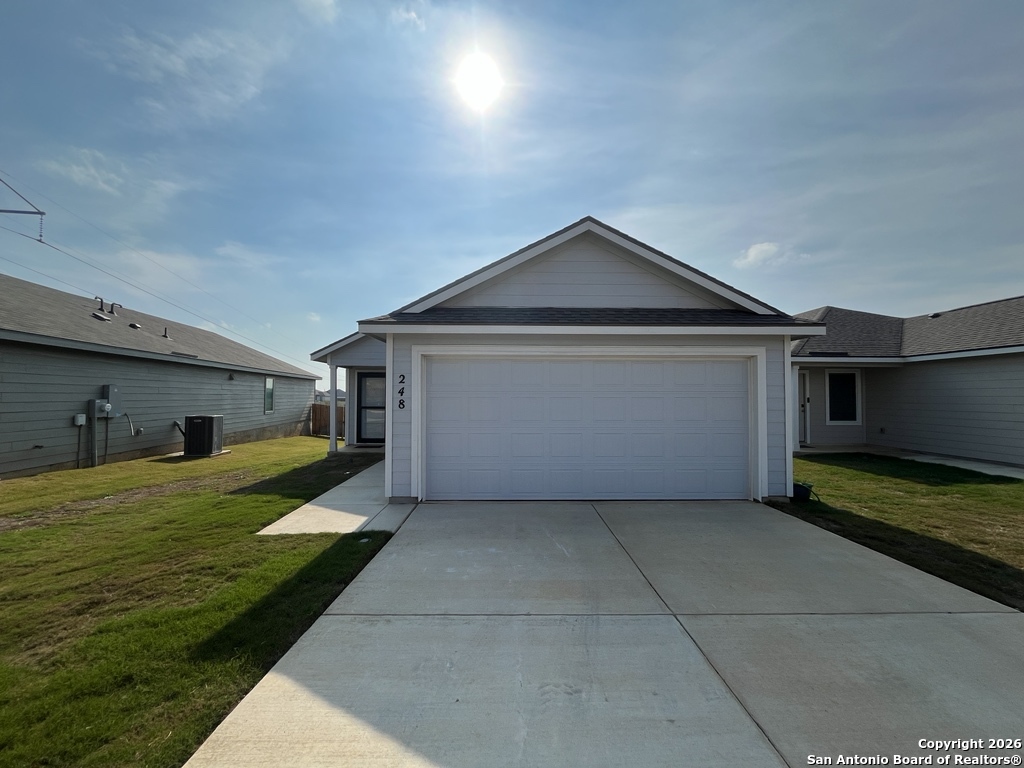 248 Cowboy Ridge Pleasanton, TX 78064 - Photo 33 of 37 a front view of a house with garden