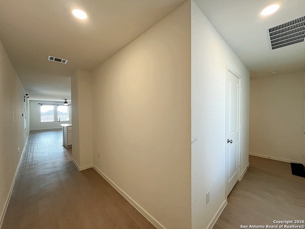248 Cowboy Ridge Pleasanton, TX 78064 - Photo 7 of 37 a view of a hallway with wooden floor