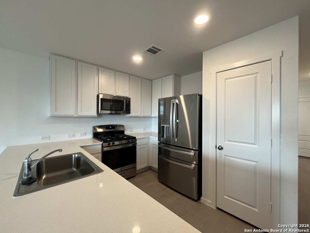 248 Cowboy Ridge Pleasanton, TX 78064 - Photo 9 of 37 a kitchen with a refrigerator sink and microwave