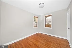 a view of a room with wooden floor and windows