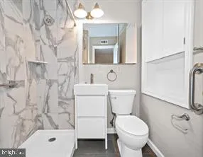 a bathroom with a toilet sink and shower