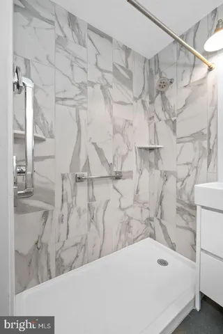 a bathroom with a bathtub and shower