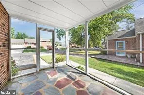 a view of a porch with furniture and garden
