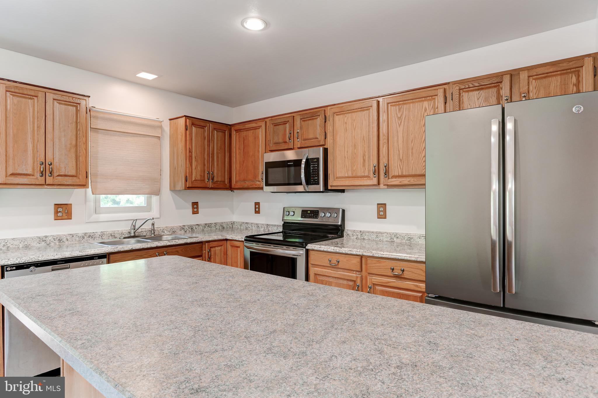 447 West Ridge Road Elizabethtown, PA 17022 - Photo 7 of 28 a kitchen with granite countertop a refrigerator stove top oven a sink and dishwasher