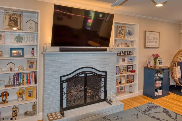 a living room with fireplace furniture and a flat screen tv
