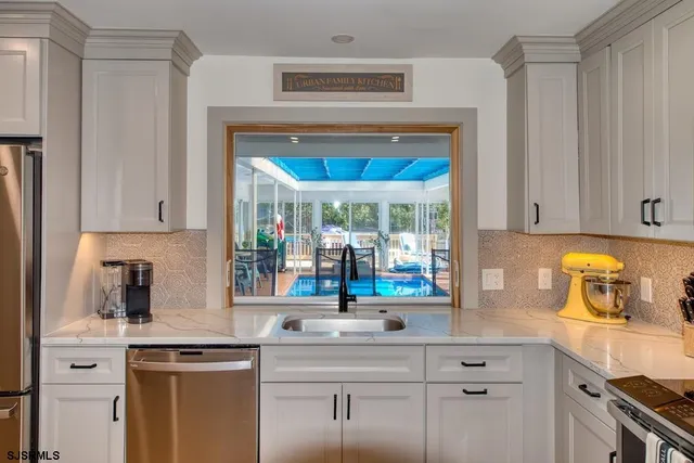 a kitchen with stainless steel appliances a stove a microwave and cabinets