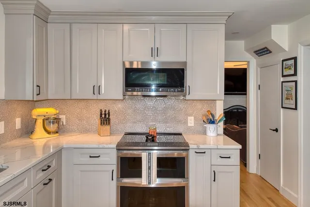 a kitchen with stainless steel appliances granite countertop a refrigerator and a sink