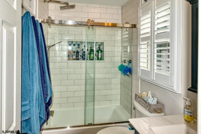 a view of a dining room with furniture and a chandelier
