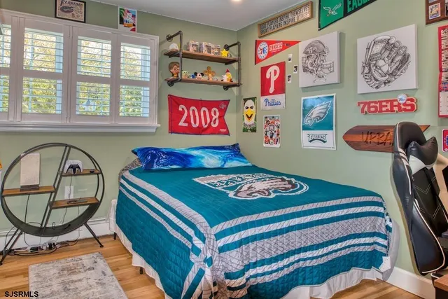 a bedroom with a bed and a painting on the wall