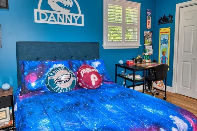 a bedroom with furniture and painting on the wall