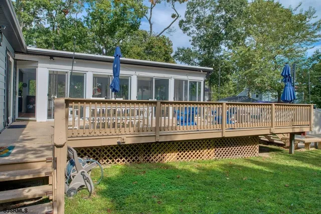 a view of a house with a wooden deck