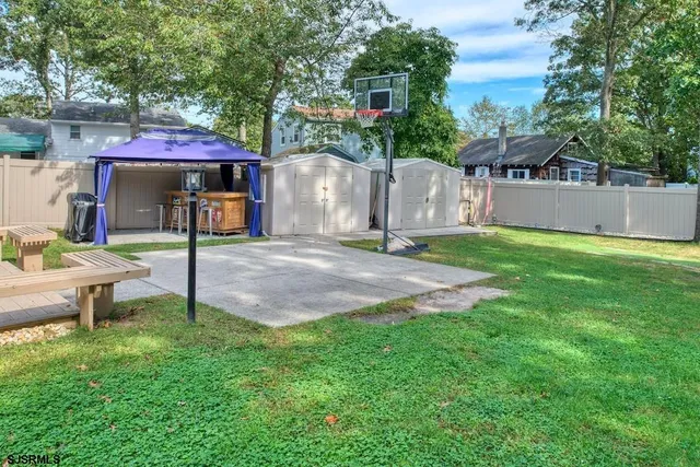 a backyard of a house with table and chairs