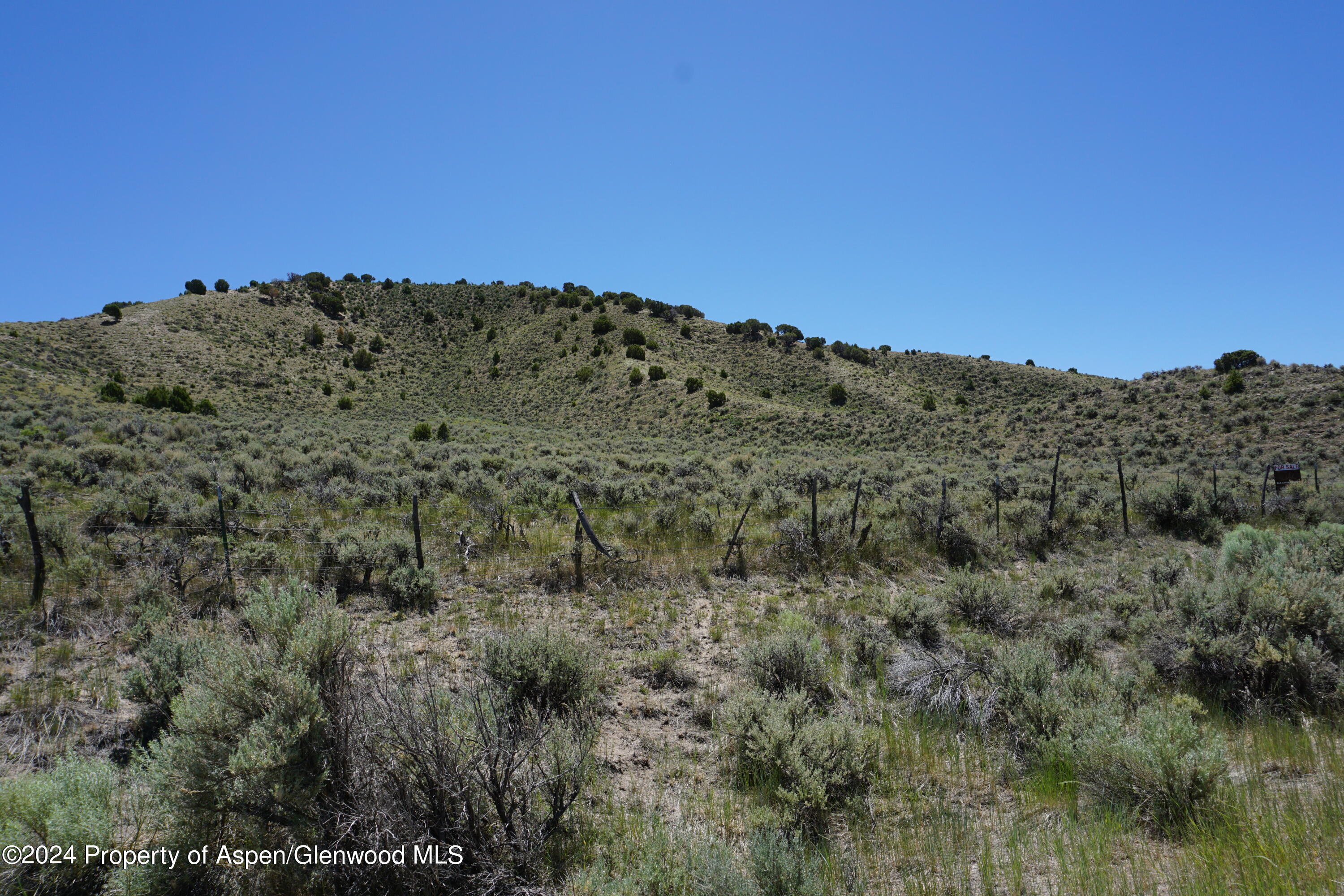57 Maybell Co 81640 Craig, CO 81625 - Photo 11 of 12 a view of a dry yard with mountains in the background