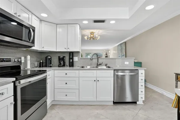 a kitchen with a sink stove and microwave
