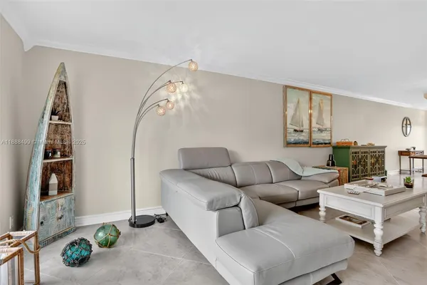 a living room with furniture and a mirror