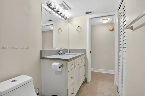 a bedroom with a bed and a chair