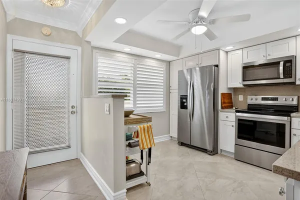a kitchen with stainless steel appliances a refrigerator and a stove top oven