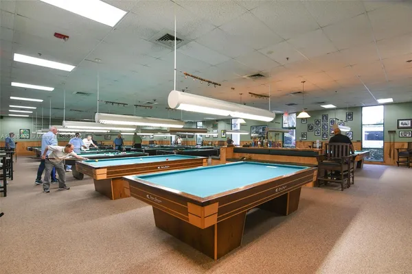 a view of a swimming pool with outdoor seating