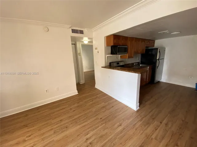 a kitchen with stainless steel appliances a refrigerator and a stove top oven