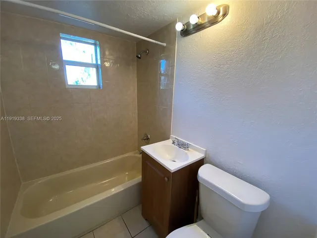 a bathroom with a toilet a sink and bathtub