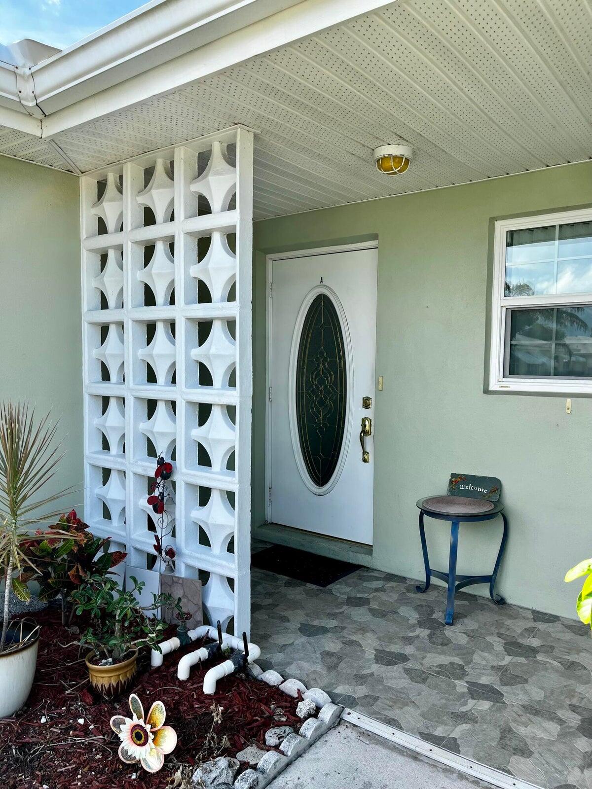 a room with a painting on the wall and a potted plant
