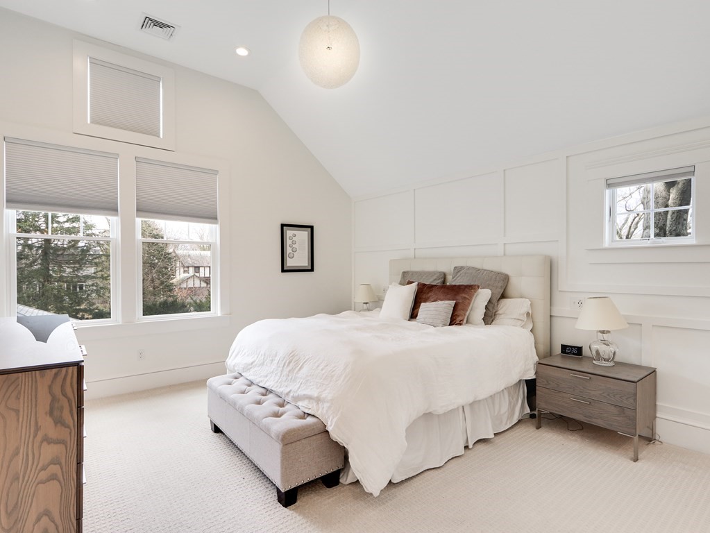 18 Brackett Road Newton, MA 02458 - Photo 17 of 32 a spacious bedroom with a bed and a large window
