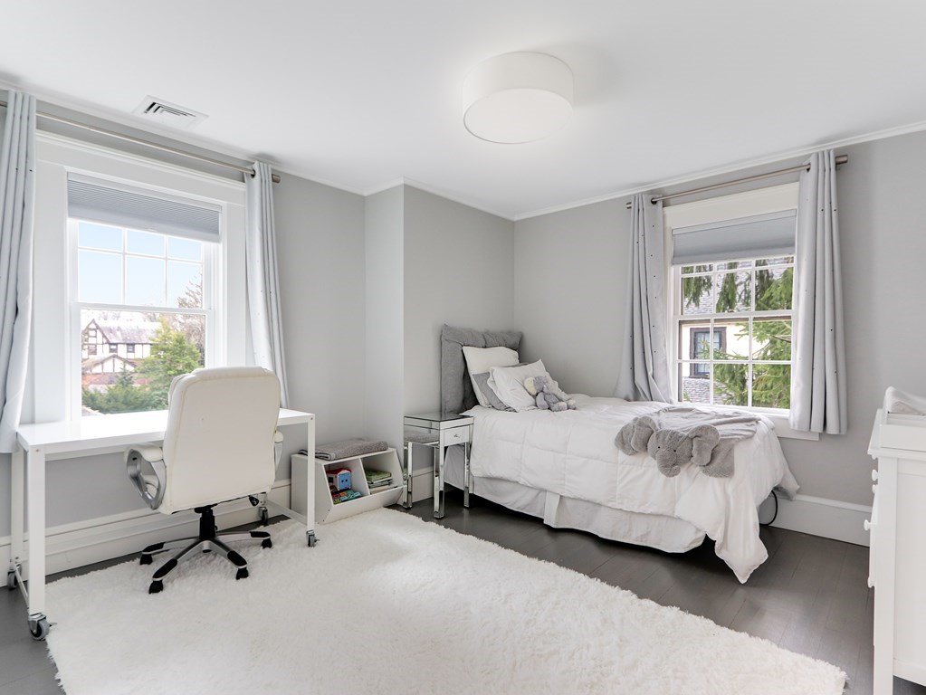 18 Brackett Road Newton, MA 02458 - Photo 20 of 32 a spacious bedroom with a bed and a chair