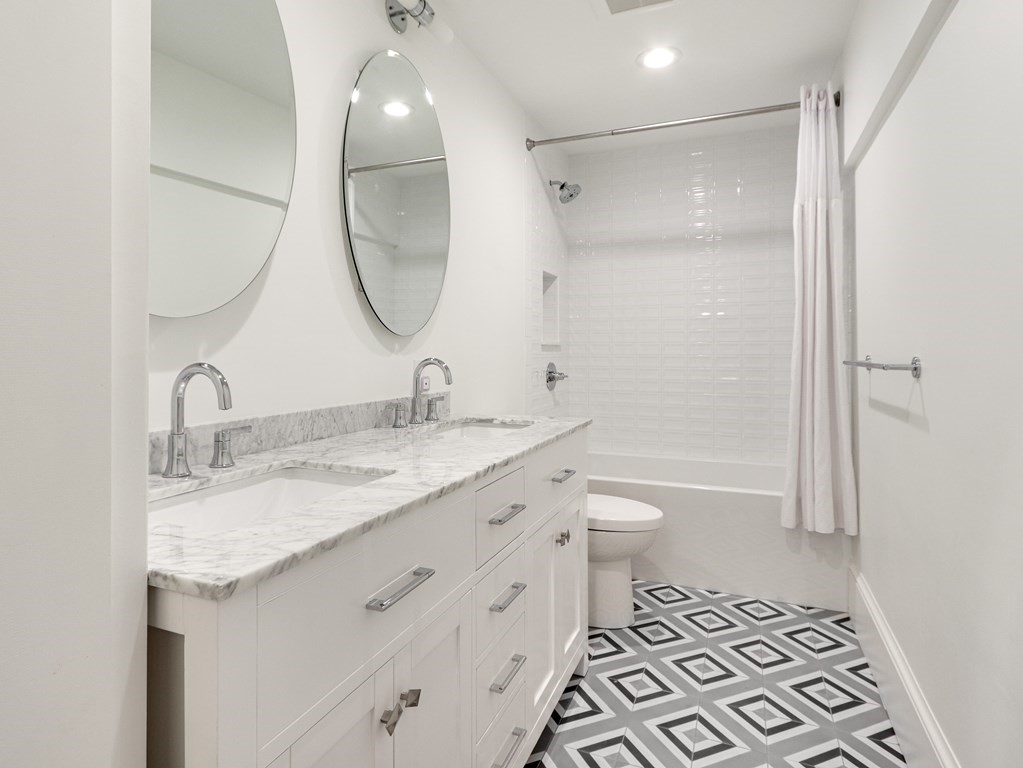 18 Brackett Road Newton, MA 02458 - Photo 22 of 32 a bathroom with a granite countertop sink toilet and a mirror