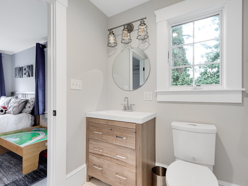 18 Brackett Road Newton, MA 02458 - Photo 24 of 32 a bathroom with a toilet sink and mirror
