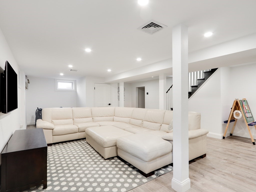 18 Brackett Road Newton, MA 02458 - Photo 25 of 32 a living room with furniture and a flat screen tv