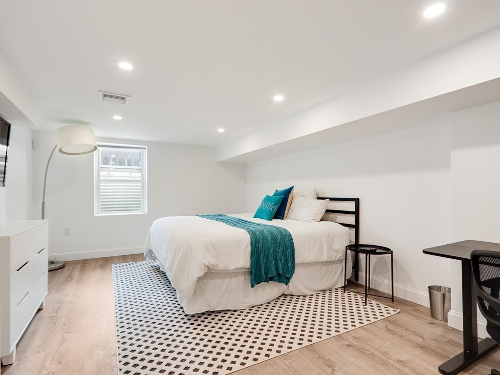 18 Brackett Road Newton, MA 02458 - Photo 27 of 32 a bedroom with a bed and a table