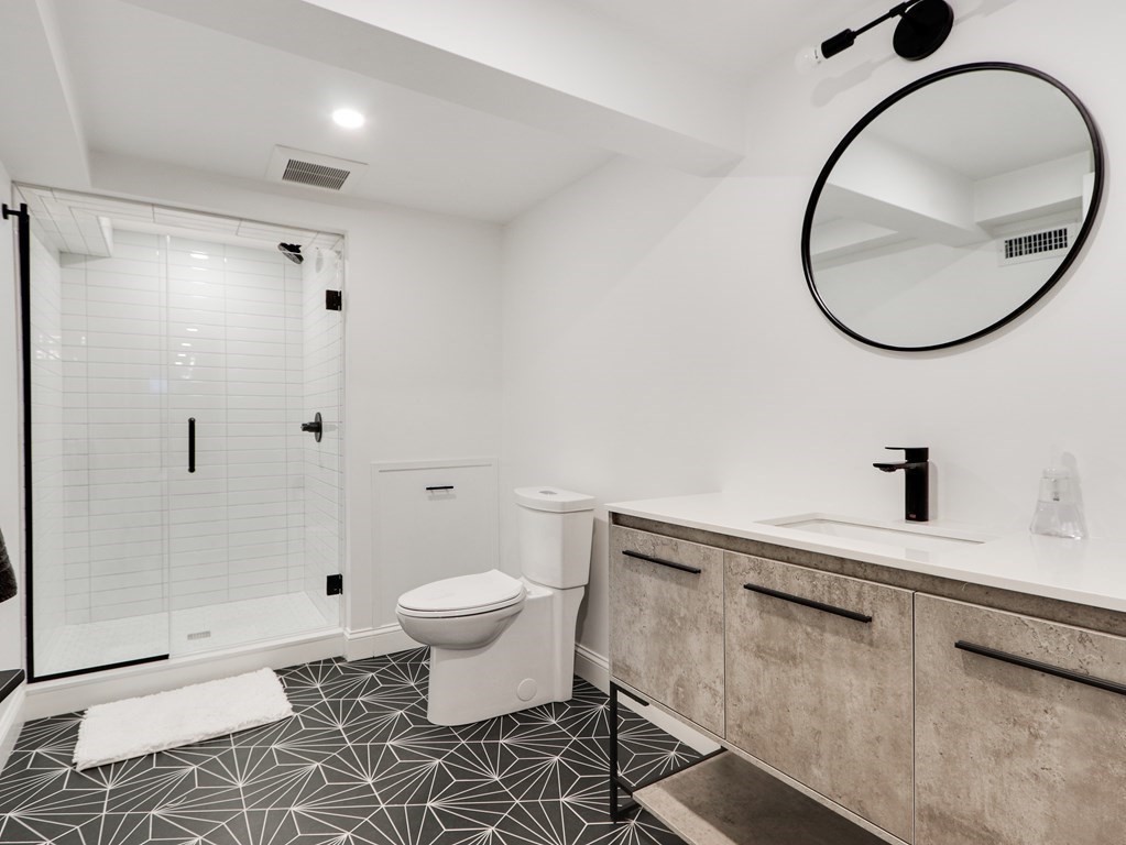 18 Brackett Road Newton, MA 02458 - Photo 28 of 32 a bathroom with a sink a toilet and a mirror