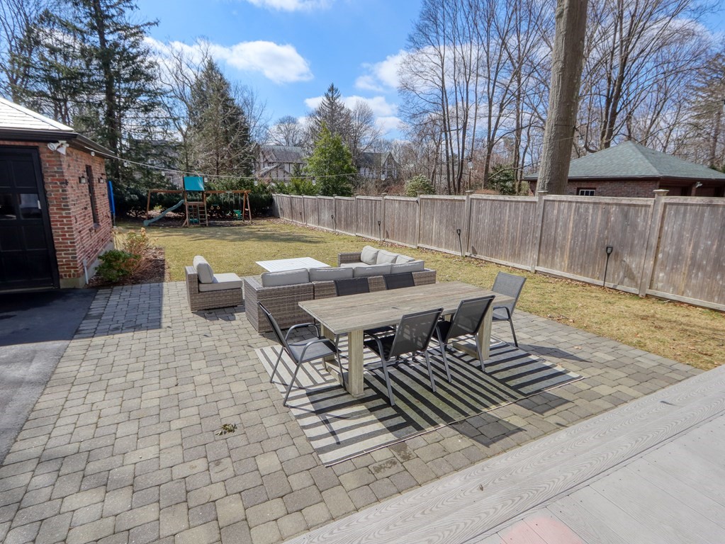 18 Brackett Road Newton, MA 02458 - Photo 31 of 32 a view of a patio with table and chairs with wooden floor and fence