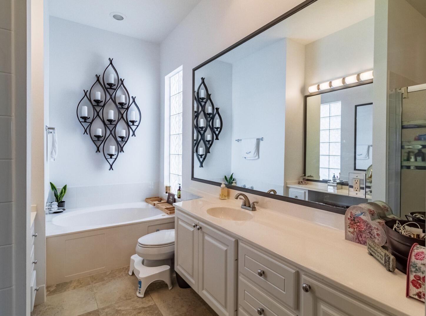 11355 Southwest Rockingham Drive Port St. Lucie, FL 34987 - Photo 17 of 31 a spacious bathroom with a bathtub sink and mirror
