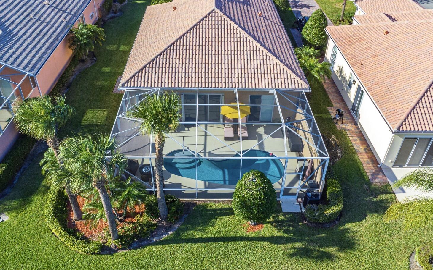 11355 Southwest Rockingham Drive Port St. Lucie, FL 34987 - Photo 24 of 31 a view of house with garden and tall trees