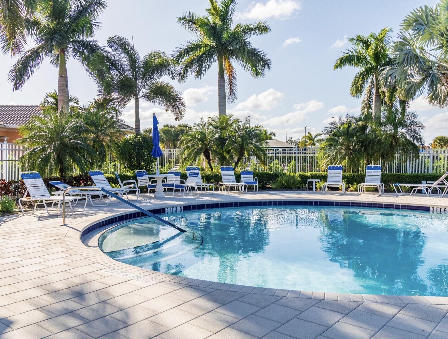 11355 Southwest Rockingham Drive Port St. Lucie, FL 34987 - Photo 28 of 31 a view of a swimming pool and a chair