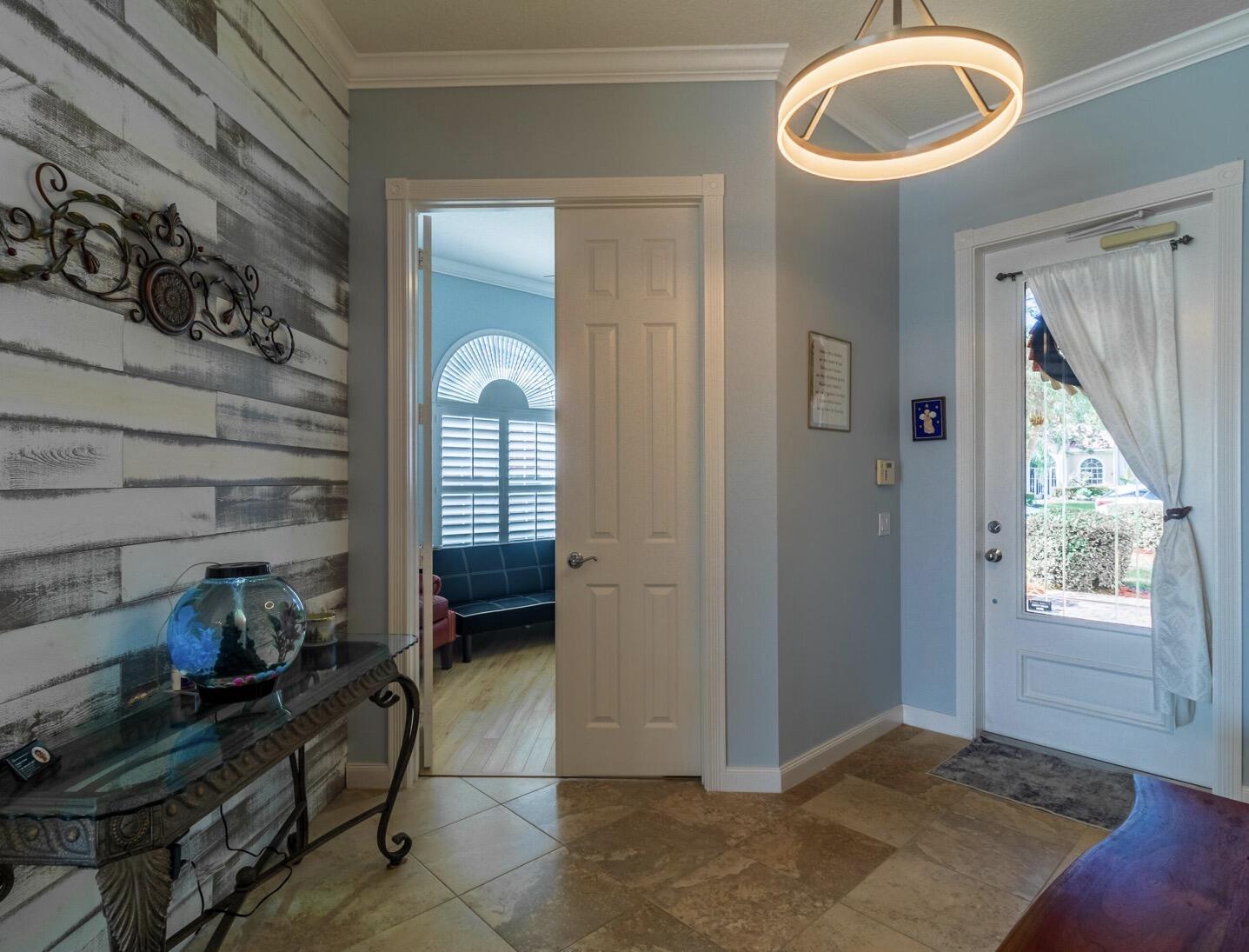 11355 Southwest Rockingham Drive Port St. Lucie, FL 34987 - Photo 3 of 31 a view of an entryway with wooden floor