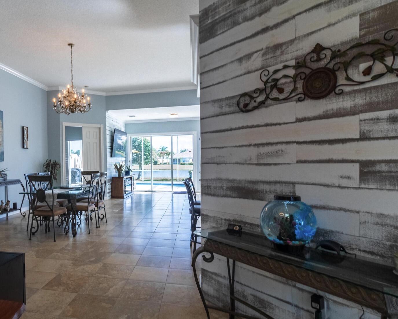 11355 Southwest Rockingham Drive Port St. Lucie, FL 34987 - Photo 4 of 31 a dining room with furniture and a chandelier