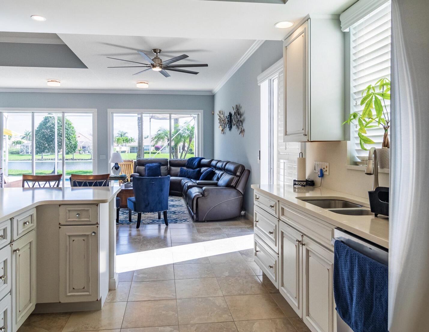 11355 Southwest Rockingham Drive Port St. Lucie, FL 34987 - Photo 8 of 31 a kitchen with a stove a sink a counter top space and living room view