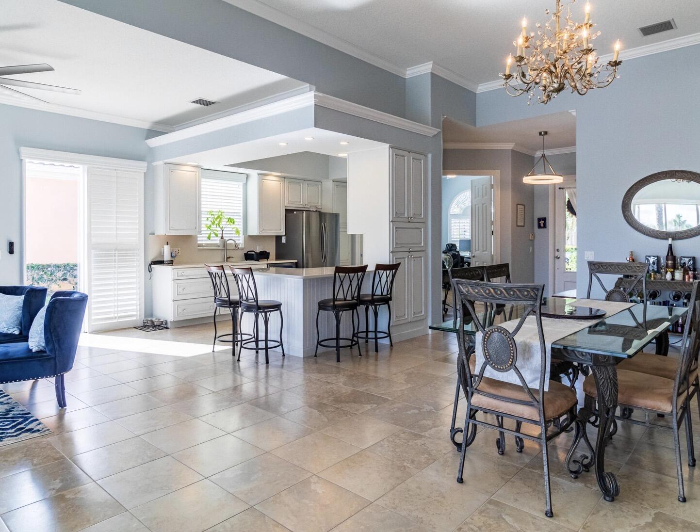 11355 Southwest Rockingham Drive Port St. Lucie, FL 34987 - Photo 10 of 31 a view of a dining room with furniture and chandelier