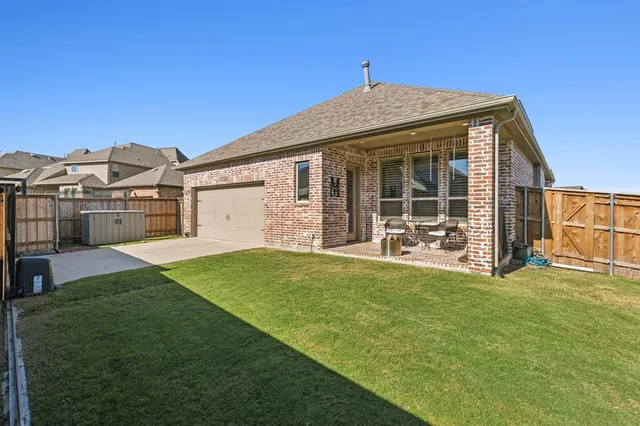 a view of a house with backyard porch and sitting area