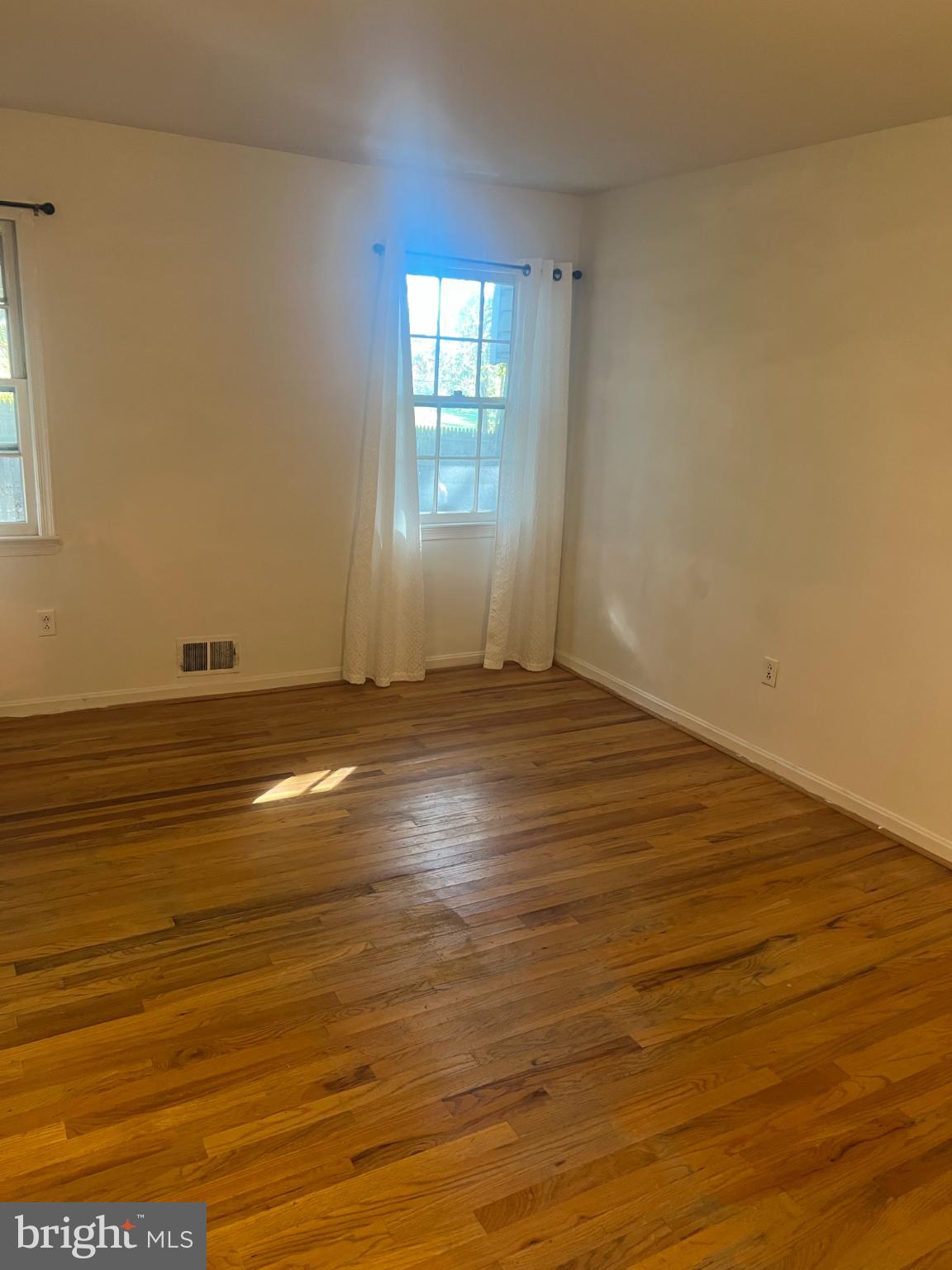 215 Summit Hall Road Gaithersburg, MD 20877 - Photo 11 of 20 an empty room with wooden floor and windows