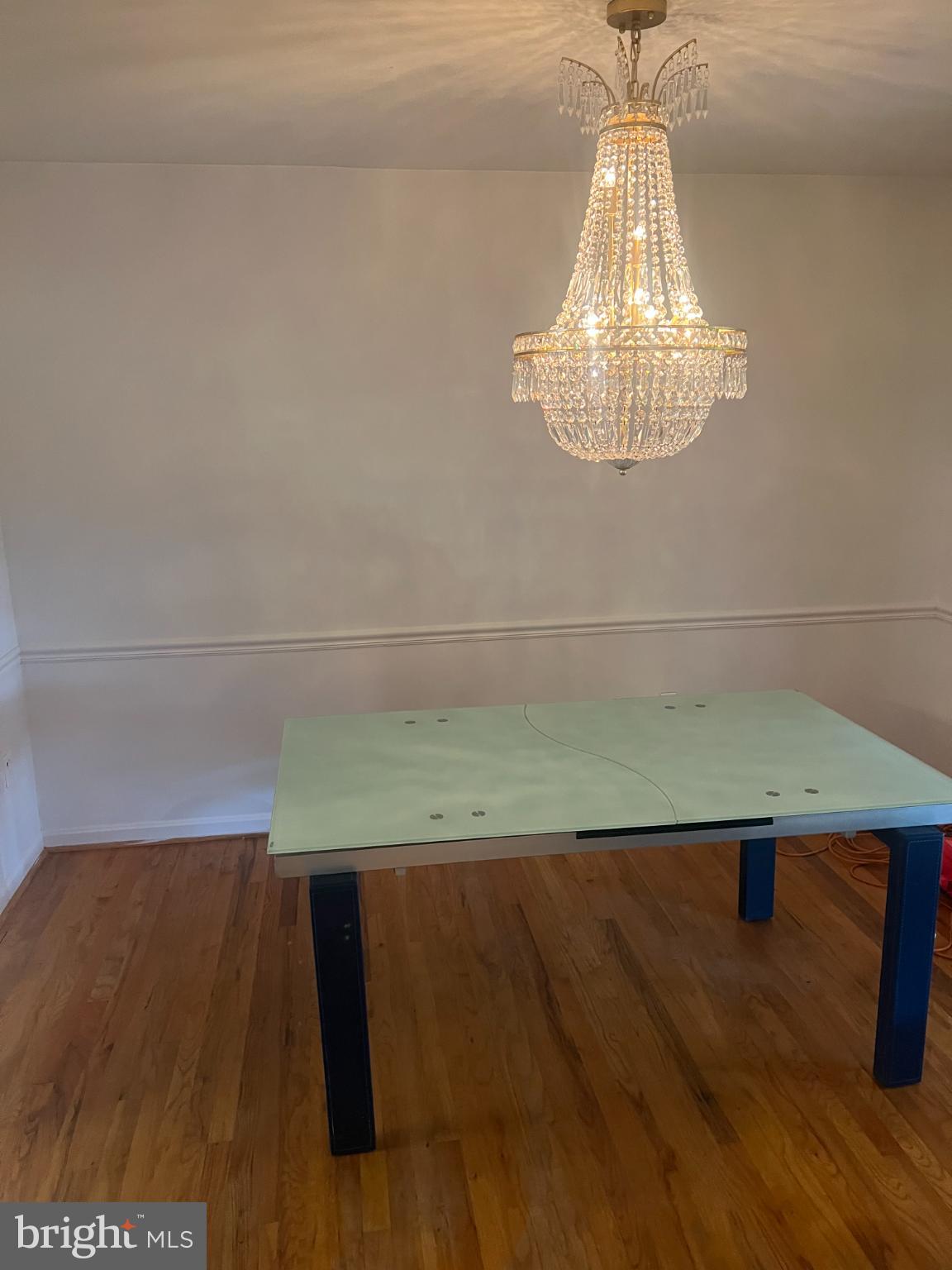 215 Summit Hall Road Gaithersburg, MD 20877 - Photo 12 of 20 a view of a room with a chandelier and wooden floor